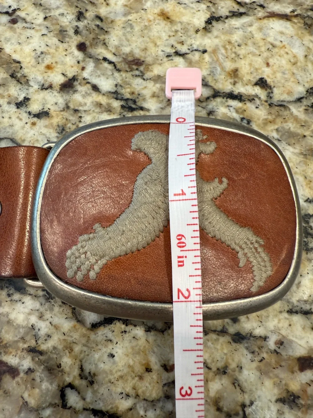 Eagle embroidered bold buckle on a light brown leather belt 44”